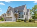 Beautiful two-story home with a gray roof, gray garage door, and nicely manicured front lawn at 1400 Hedgelawn, Raleigh, NC 27615
