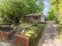 This home features a charming exterior and a well-manicured lawn at 1402 W Lakewood Ave, Durham, NC 27707