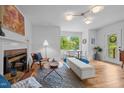 Bright living room featuring a fireplace, hardwood floors, and a view of the outdoors at 1402 W Lakewood Ave, Durham, NC 27707