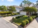 Well-kept home exterior featuring green lawn, driveway and manicured bushes, a great curb appeal at 141 Hilda Grace Ln, Cary, NC 27519