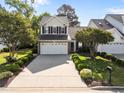 Beautiful two-story home with lush landscaping, a long driveway, and a well-manicured lawn at 141 Hilda Grace Ln, Cary, NC 27519