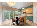 Bright kitchen featuring a center island with seating, modern appliances, and large sliding glass doors at 141 Hilda Grace Ln, Cary, NC 27519