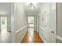 Bright hallway featuring hardwood floors, white trim and doors leading to other rooms at 1429 Raybon Dr, Wendell, NC 27591