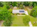 An aerial perspective of a residential house showcasing solar panels and a serene, tree-filled surrounding at 149 Baldwin Dr, Durham, NC 27712