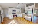 Modern kitchen featuring stainless steel appliances and bright white cabinets at 1622 Julian Oakley Rd, Rougemont, NC 27572