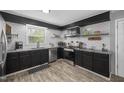 Modern kitchen featuring granite countertops, stainless steel appliances, and dark wood cabinetry at 2005 Chalybeate Springs Rd, Fuquay Varina, NC 27526