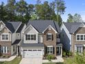 Charming two-story home with a combination of stone and siding, complemented by a well-manicured lawn at 2323 Big Sky Ln, Raleigh, NC 27615