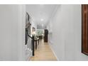 Bright hallway with light hardwood floors and access to the living area and staircase at 2323 Big Sky Ln, Raleigh, NC 27615