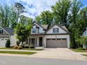 Charming one-story home with a two-car garage and a welcoming front porch at 2472 Patriot Bluffs Dr, Fuquay Varina, NC 27526