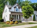 Charming two-story home with a welcoming front porch and landscaped yard at 2472 Patriot Bluffs Dr, Fuquay Varina, NC 27526