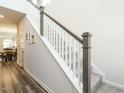 Bright staircase with white railings, gray trim, and carpeted steps leading to the upper level of the home at 253 Sweet Olive St, Clayton, NC 27527
