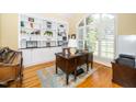 Bright home office with custom built-in shelves, hardwood floors, and large windows at 2633 Penfold Ln, Wake Forest, NC 27587