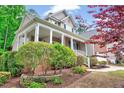 Inviting front porch with brick accents, columns, and lush landscaping at 2639 Oleander Dr, Durham, NC 27703