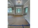 Bright entryway featuring a white door with glass panels, white trim, and contemporary lighting fixture at 27 Batten Hill Ln, Selma, NC 27576