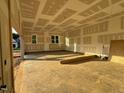 Spacious garage with ample natural light, offering potential for a functional workspace or storage solution at 27 Batten Hill Ln, Selma, NC 27576