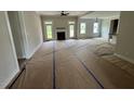 Spacious living room with a cozy fireplace and ample natural light from large windows at 27 Batten Hill Ln, Selma, NC 27576