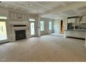 Bright living room with fireplace, with abundant natural light, seamlessly connecting to the kitchen and dining area at 27 Batten Hill Ln, Selma, NC 27576