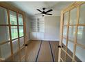 Office with built-in bookshelves and glass French doors, offering a bright and functional workspace at 27 Batten Hill Ln, Selma, NC 27576
