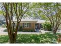 Lovely brick home with a beautifully landscaped yard and mature trees providing shade and character at 2715 Freemont Rd, Durham, NC 27705