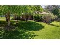 Inviting brick home features a manicured lawn and mature trees, creating a serene and welcoming atmosphere at 2715 Freemont Rd, Durham, NC 27705