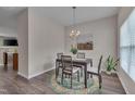 Cozy dining area with modern lighting, a dark wood table, and a decorative rug at 3114 Courtney Creek Blvd, Durham, NC 27713