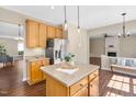Open-concept kitchen with island, pendant lighting, stainless steel appliances, and eat in dining at 3302 Colorcott St, Raleigh, NC 27614