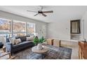 Bright living room with large windows, hardwood floors, stylish furniture, and an open airy feel at 3408 Brentwood Rd, Raleigh, NC 27604