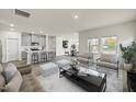 Open-concept living room and kitchen with modern decor, gray tones and lots of natural light at 441 White Birch Ln # 66, Angier, NC 27501