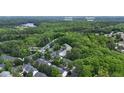 Aerial view of the community with mature trees near NC State, Lake Johnson, and Downtown Raleigh at 4540 Mistiflower Dr, Raleigh, NC 27606