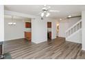 Open floor plan features modern floors, a ceiling fan, stairs, and half bath at 4602 Millstone Dr # C, Raleigh, NC 27604
