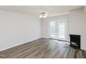 Bright living room features modern floors, a fireplace, and French doors at 4602 Millstone Dr # C, Raleigh, NC 27604