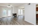 Bright living room boasts modern floors, a fireplace, and French doors to backyard at 4602 Millstone Dr # C, Raleigh, NC 27604