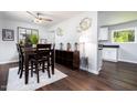 Dining area with dark wood floors, view to kitchen, and natural lighting at 4908 Vallery Pl, Raleigh, NC 27604