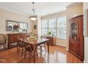 Bright dining room with hardwood floors and large window, perfect for entertaining at 5026 Celtic Ct, Raleigh, NC 27612