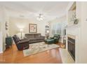 Cozy living room with a fireplace, plush seating, and natural light at 5026 Celtic Ct, Raleigh, NC 27612
