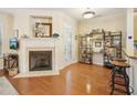 Inviting living room with a fireplace, hardwood floors, and a view to the outside at 5026 Celtic Ct, Raleigh, NC 27612