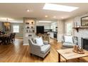 Open-concept living space with skylights, hardwood floors, and a view into the kitchen and dining area at 508 Colony Woods Dr, Chapel Hill, NC 27517