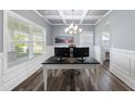Bright home office with coffered ceiling, modern light fixture, and wood-look flooring at 509 National Dr, Clayton, NC 27520