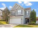 Traditional two-story home boasts a well-maintained lawn and an attached two-car garage at 5204 Nautical Ln, Raleigh, NC 27610