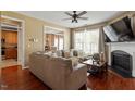 Comfortable living room showcases a stylish fireplace, a large sectional, and seamless flow to the dining area at 5204 Nautical Ln, Raleigh, NC 27610