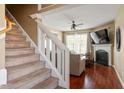Inviting living room with a cozy fireplace and staircase leading to the upper level at 5204 Nautical Ln, Raleigh, NC 27610