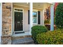Close up of front door and entryway framed by lush landscaping at 5515 S Roxboro St # 23, Durham, NC 27713