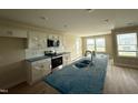 Modern kitchen with stainless steel appliances, white cabinets, and a center island at 56 Ruskin Dr, Smithfield, NC 27577