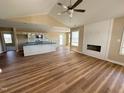 A spacious living room with hardwood flooring, a fireplace, and modern ceiling fan at 56 Ruskin Dr, Smithfield, NC 27577