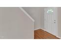 Inviting entryway featuring hardwood floors and a half-glass door at 5609 Severn Grove Dr, Durham, NC 27703