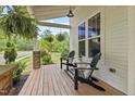 Cozy porch with chairs and decorative hanging plants for a relaxing outdoor space at 563 Great Ridge Parkway, Chapel Hill, NC 27516