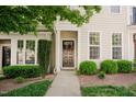 Charming two-story townhome with a well-maintained lawn and inviting front entrance at 5710 Corbon Crest Ln, Raleigh, NC 27612