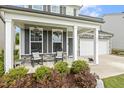 Inviting front porch with rocking chairs, complemented by well-manicured landscaping and a two-car garage at 575 Dawley Dr, Fuquay Varina, NC 27526