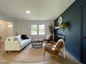 Stylishly decorated living room with modern furniture, fireplace, and ample natural light at 5817 Wintergreen Dr, Raleigh, NC 27609