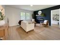 Bright living area with modern decor, light wood floors and an electric fireplace at 5817 Wintergreen Dr, Raleigh, NC 27609